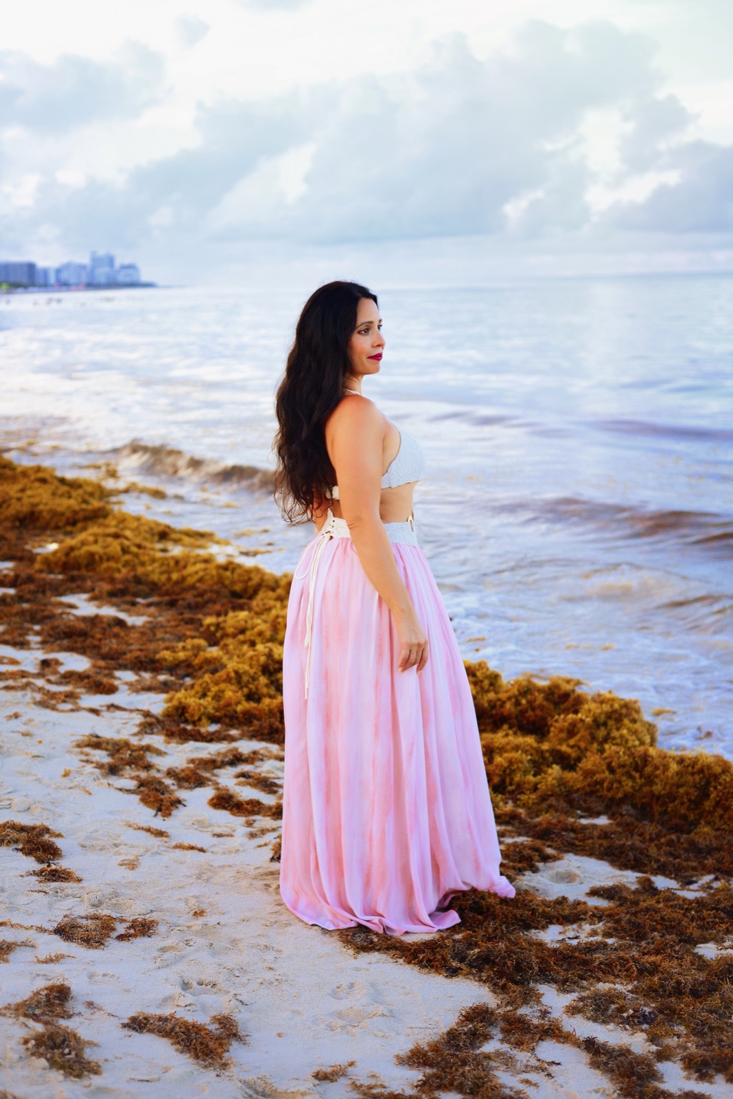 Jennifer Nicole standing at the shoreline in soft morning light