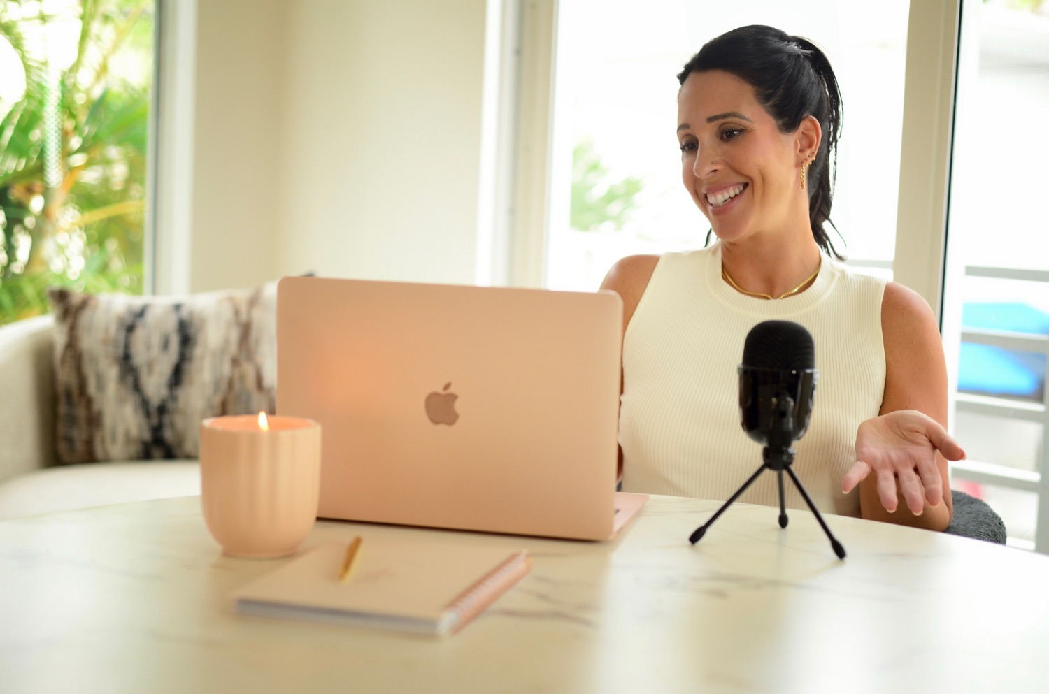 Jennifer Nicole recording her podcast at a bright desk